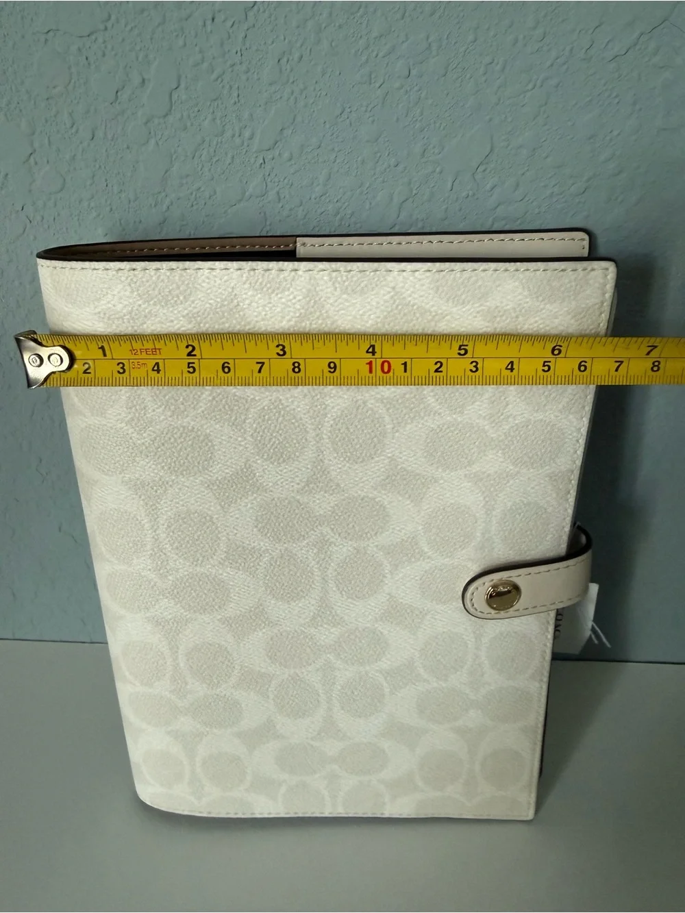Brand new white coach notebook.